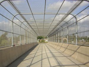 Chain link/ steel fencing covering bridge over highway installed by the contractors that work at Collinson Inc.