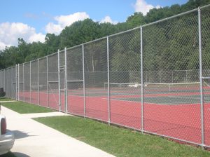 Steel fencing around a tennis court.